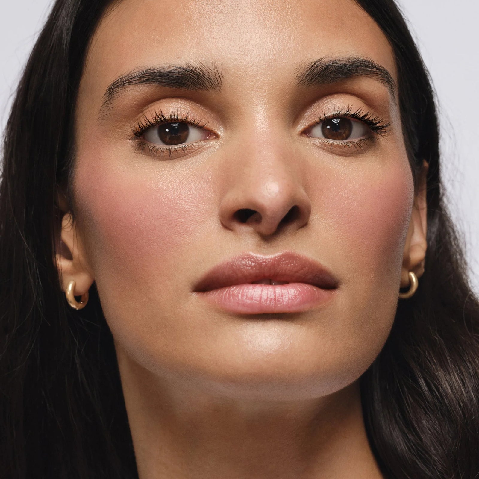 Close-up of a woman's face with a neutral background