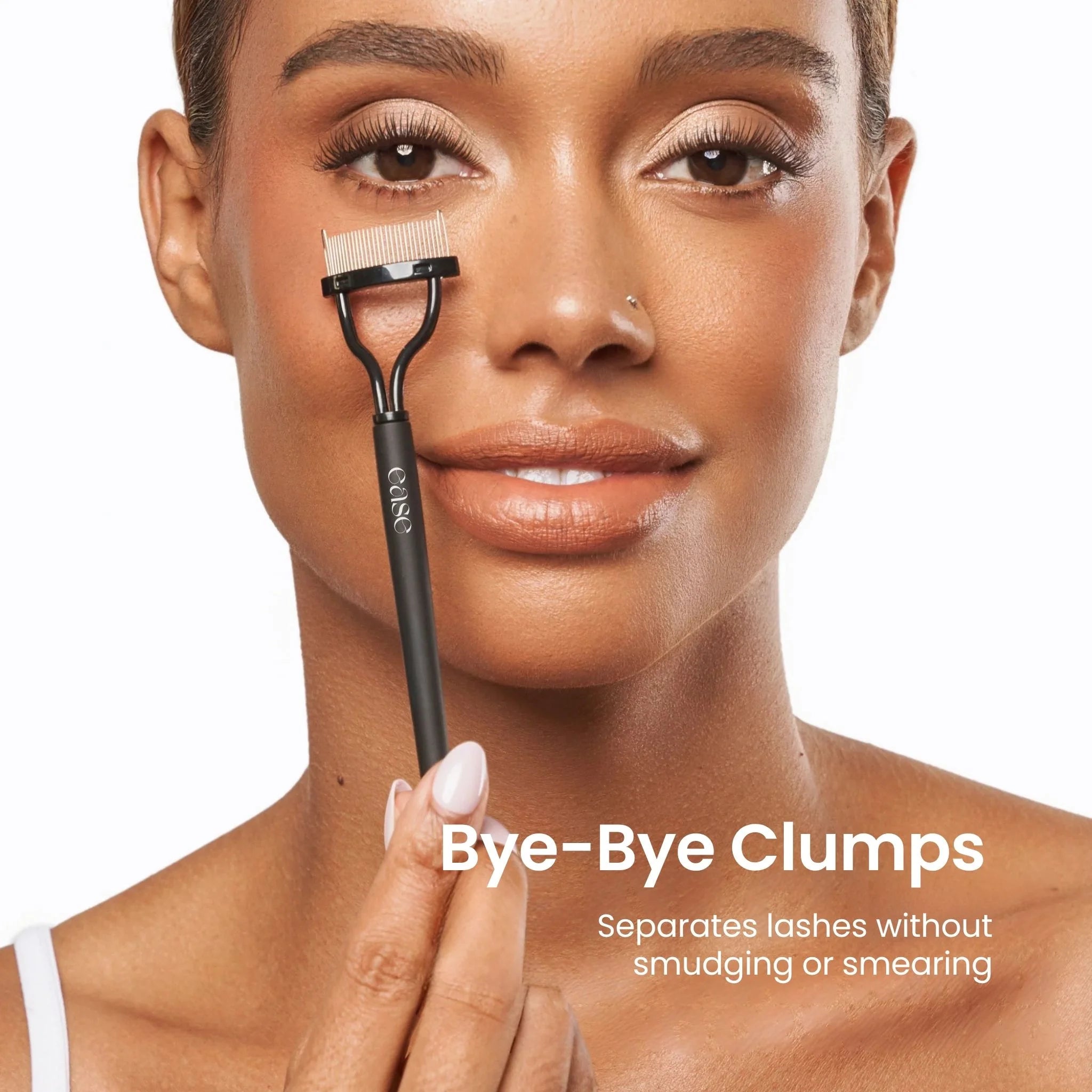 Woman holding a lash separator tool with text 'Bye-Bye Clumps' on a white background