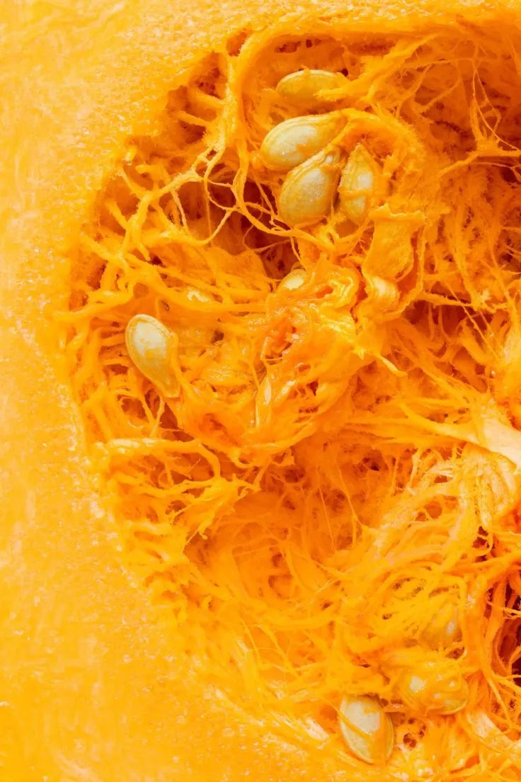 Close-up of a sliced pumpkin with seeds inside