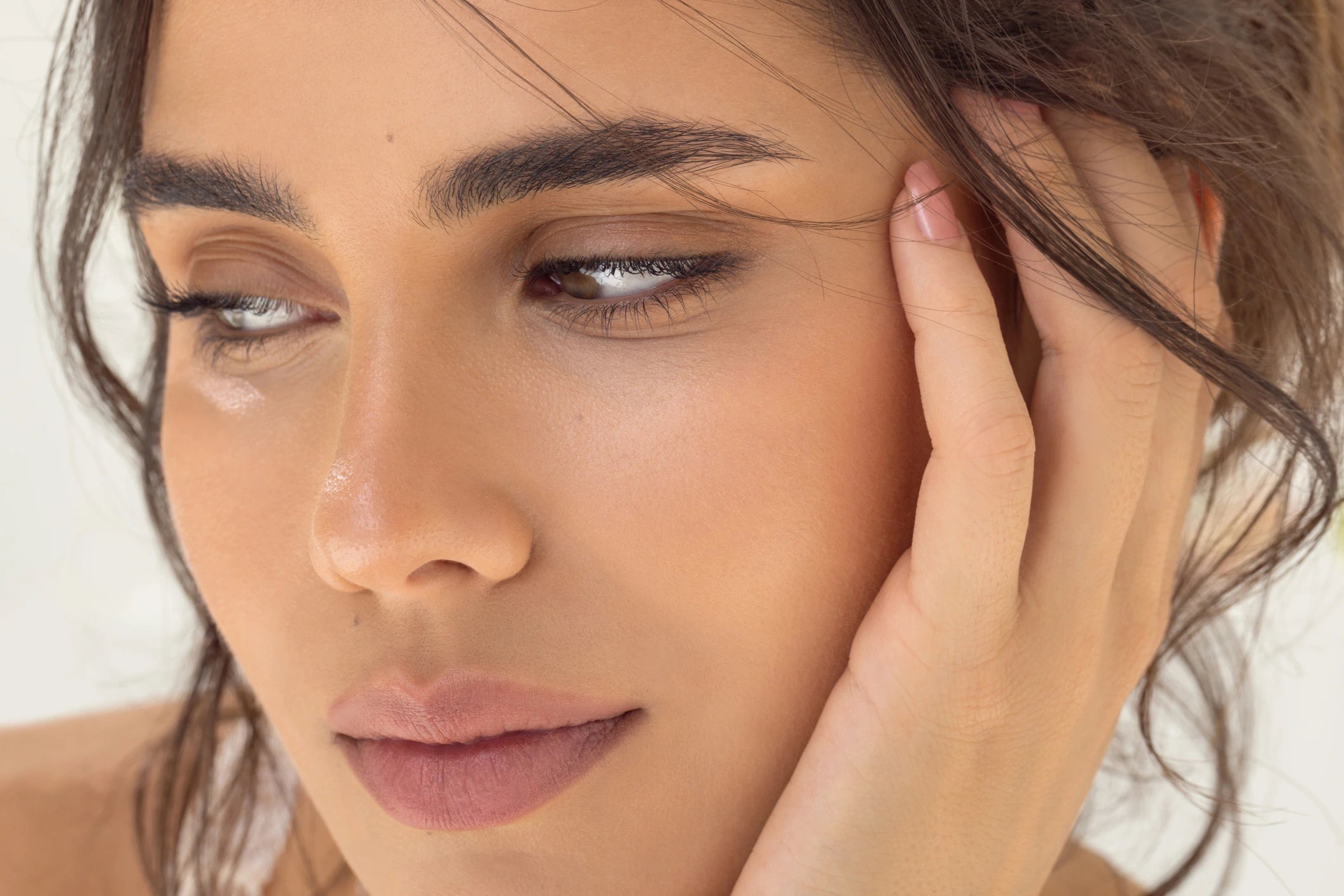 woman with natural make-up looking down